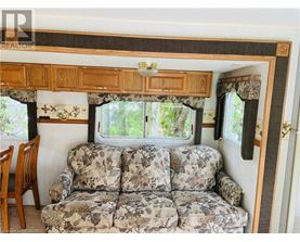 A camper with a couch and a window.