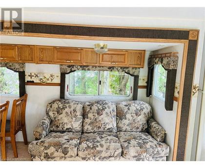 A camper with a couch and a window.