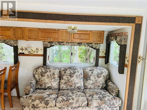 A camper with a couch and a window.