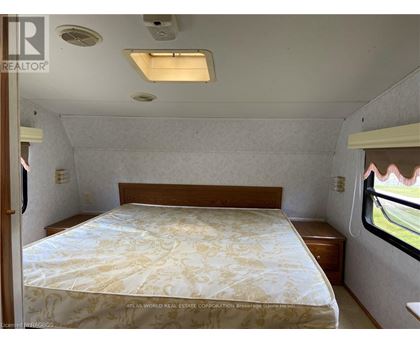 A bedroom with a bed and a window.