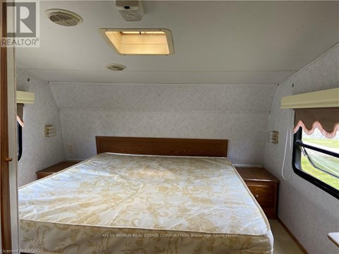A bedroom with a bed and a window.