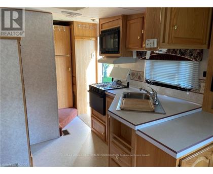 A kitchen with wooden cabinets and a white countertop.