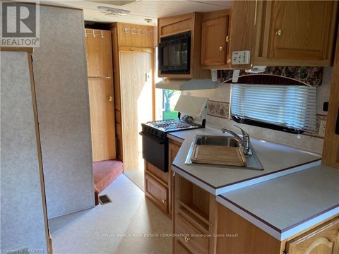 A kitchen with wooden cabinets and a white countertop.