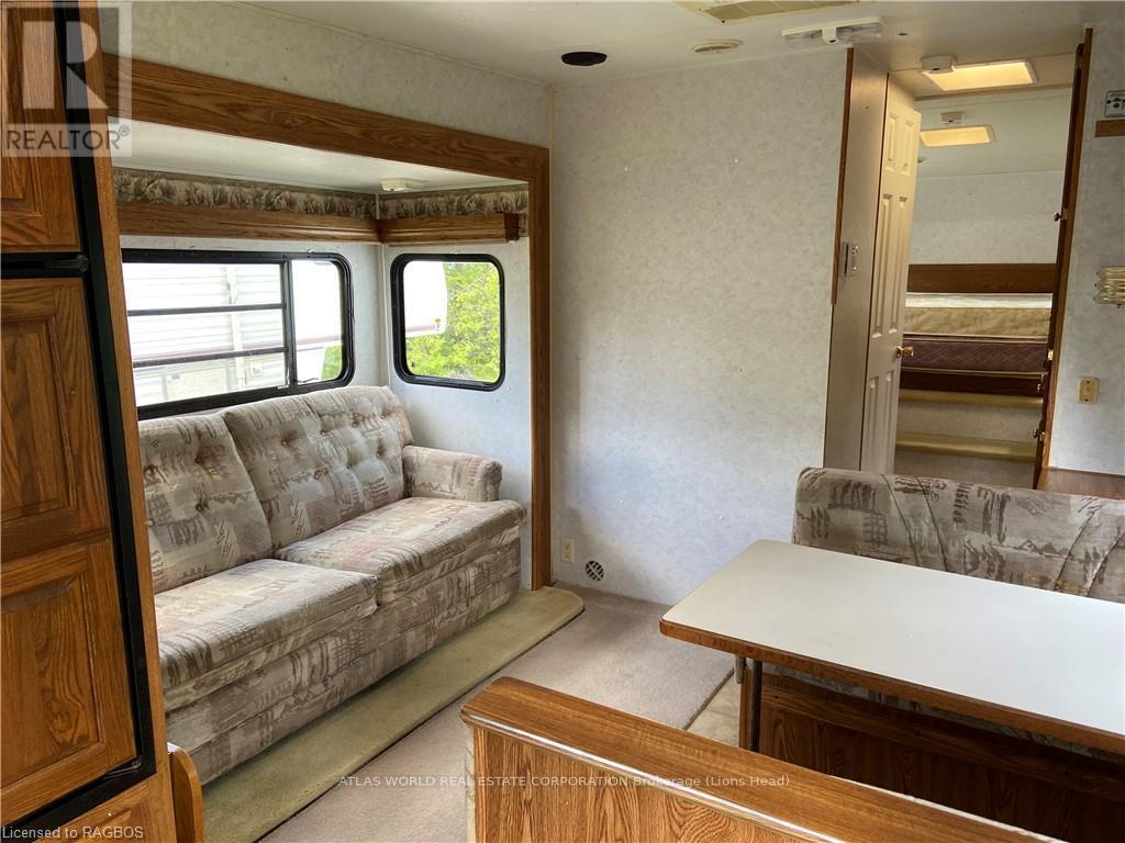 A living room with a couch, a table, and a window.
