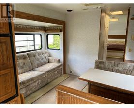 A living room with a couch, a table, and a window.