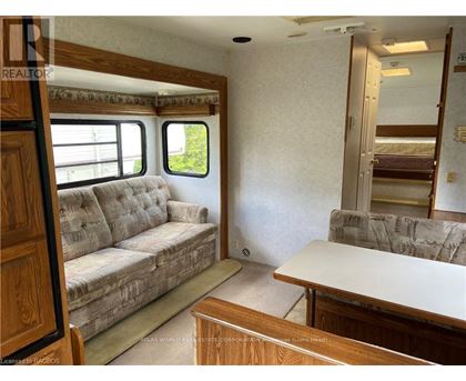 A living room with a couch, a table, and a window.