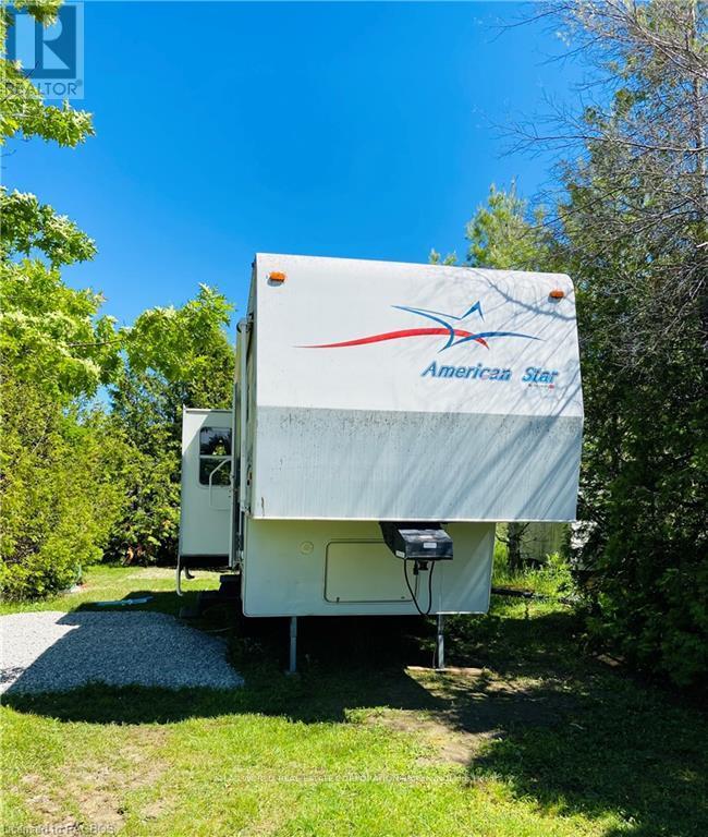 An American Star RV is parked in a grassy area.
