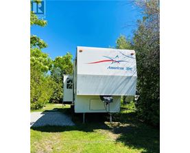 An American Star RV is parked in a grassy area.
