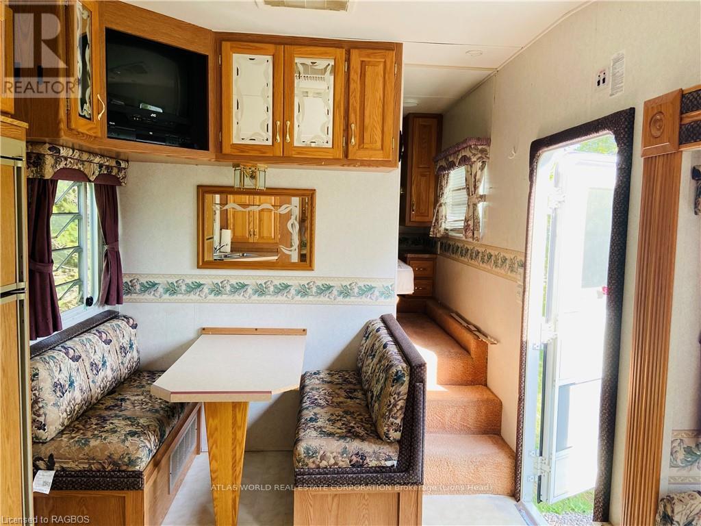 A living room with a couch, a table, and a television.