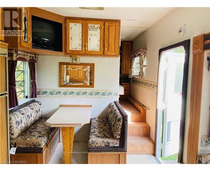 A living room with a couch, a table, and a television.