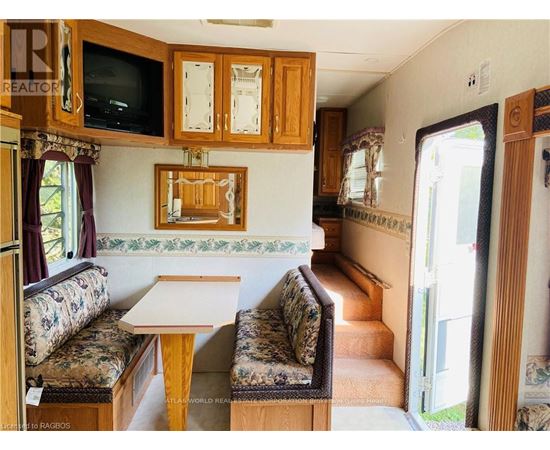 A living room with a couch, a table, and a television.