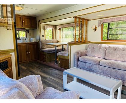 A living room with a couch, a table, and a window.