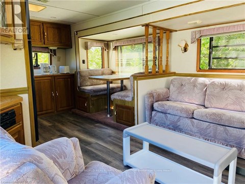 A living room with a couch, a table, and a window.