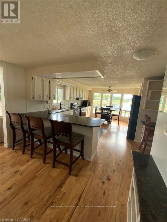 A kitchen with wooden floors and white walls.