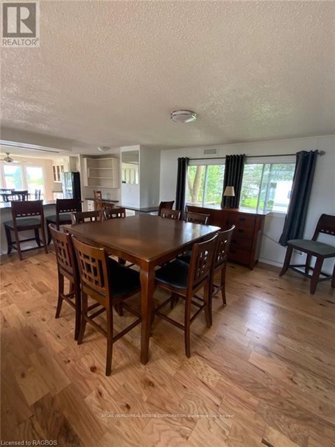 A dining room with a wooden table and chairs.