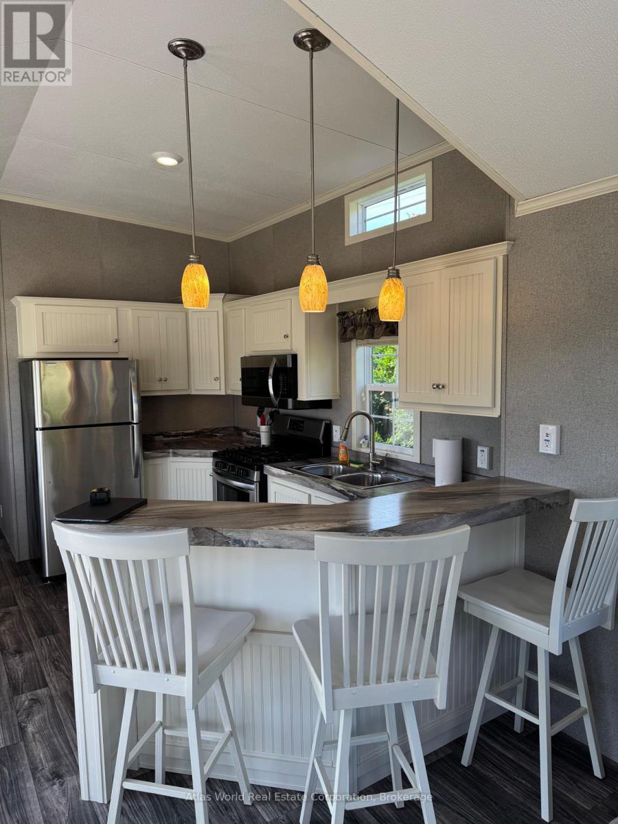 A kitchen with a table and chairs.