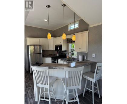 A kitchen with a table and chairs.
