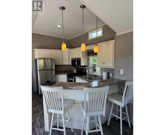 A kitchen with a table and chairs.