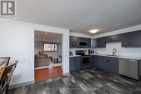 A kitchen with a dining table and chairs in the living room.