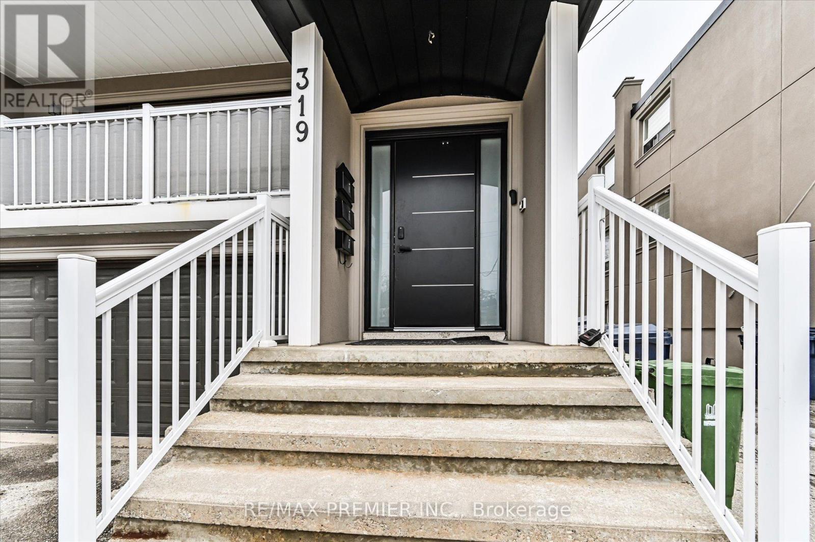 A house number 319 with a black door and white railings.