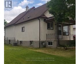 A house with a brown roof and a balcony with a railing.