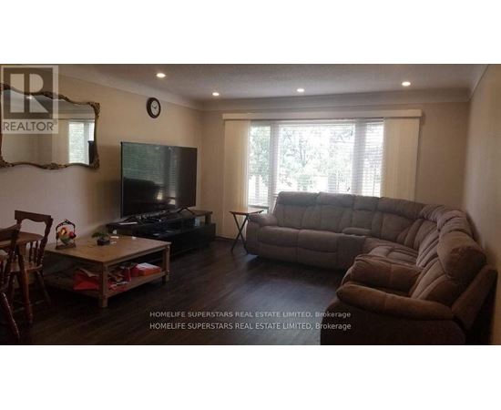 A living room with a brown couch and a flat screen TV.