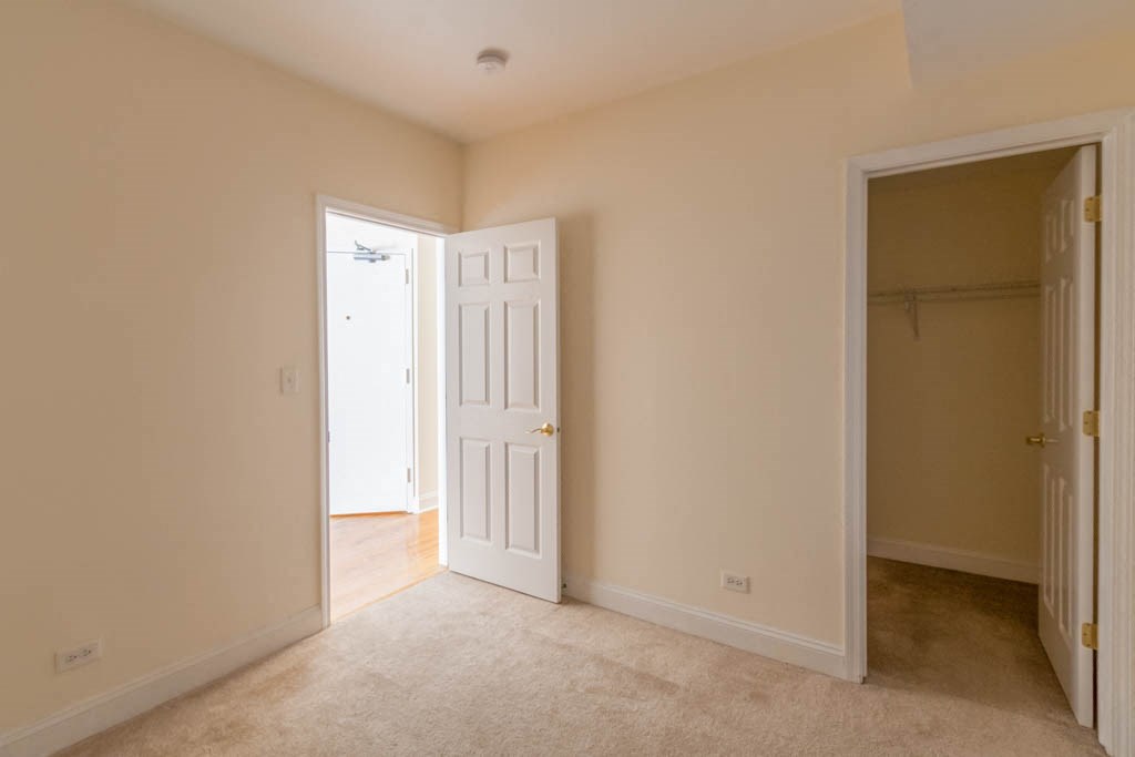 a room with an open door and a door to a closet