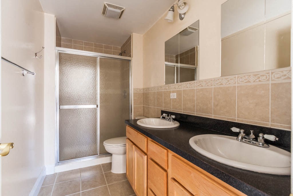 a bathroom with a sink and a toilet and a shower