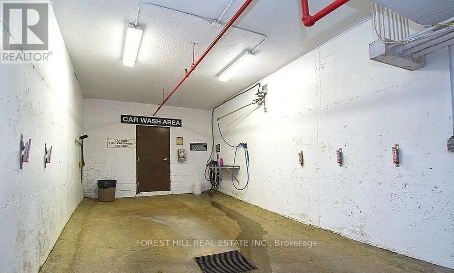 A car wash area with a sign that says "CAR WASH AREA" on the wall.