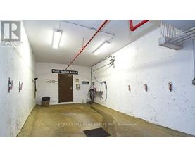 A car wash area with a sign that says "CAR WASH AREA" on the wall.