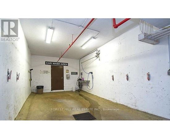 A car wash area with a sign that says "CAR WASH AREA" on the wall.