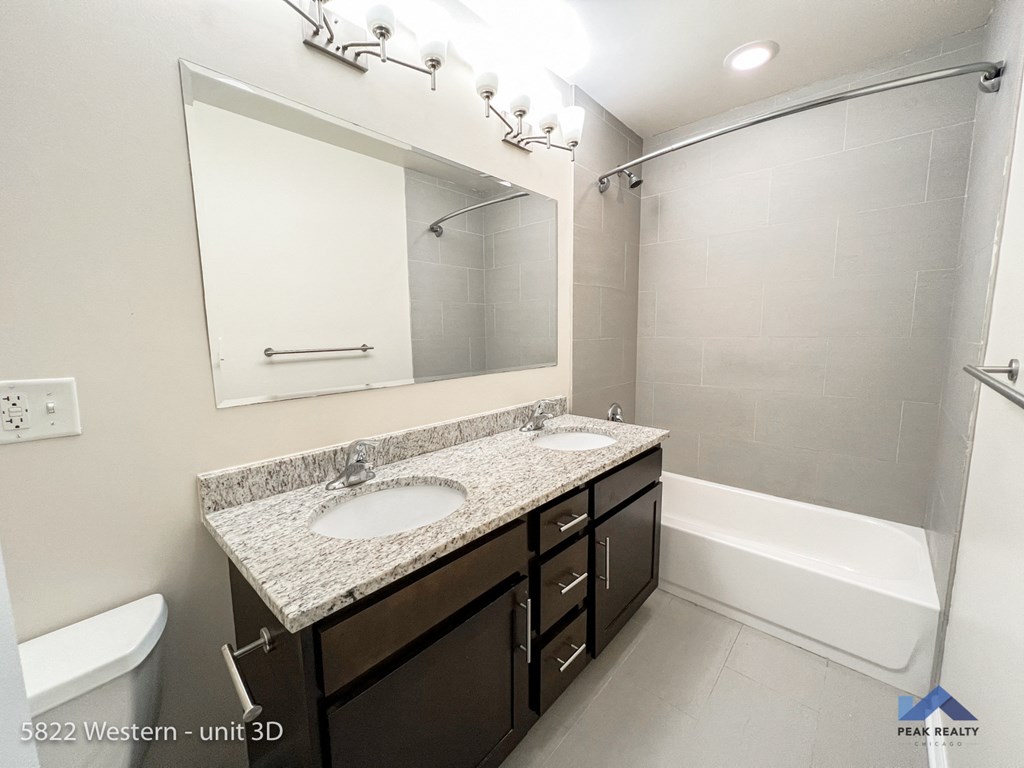 a bathroom with a sink and a mirror and a shower