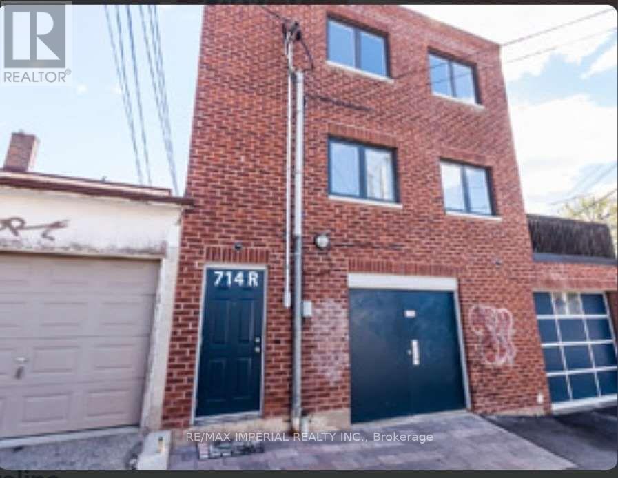 A red brick building with the number 714R on the front door.