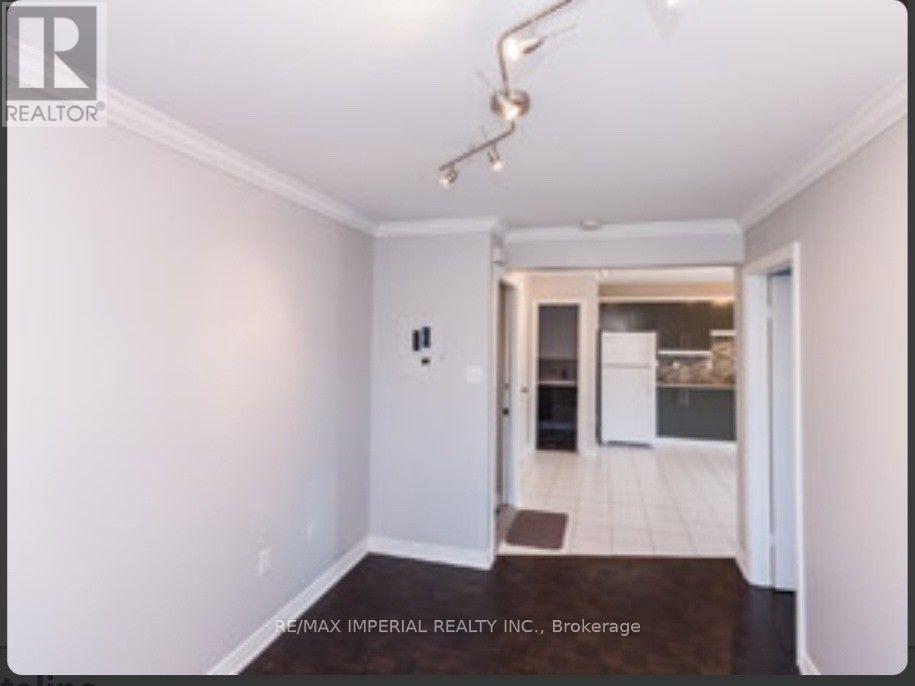 A white room with a doorway leading to another room.