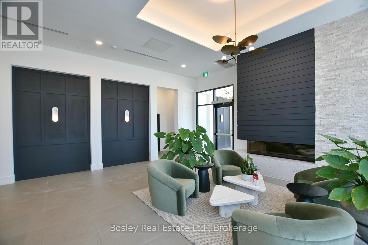 A living room with a green couch and a fan.