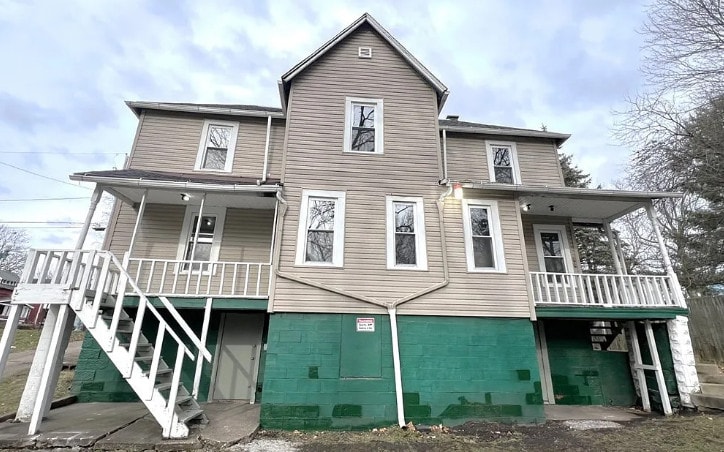 A two-story house with a balcony on the second floor.