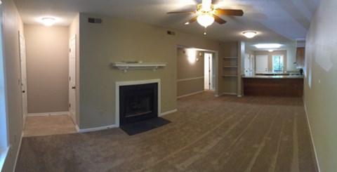 A room with a fireplace and a ceiling fan.