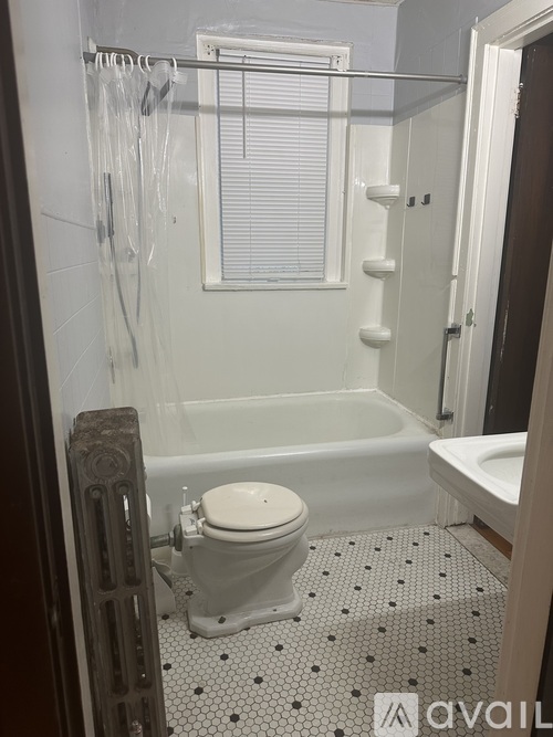 A white toilet in a bathroom with a black and white floor.