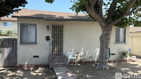 A house with a tree in front of it.