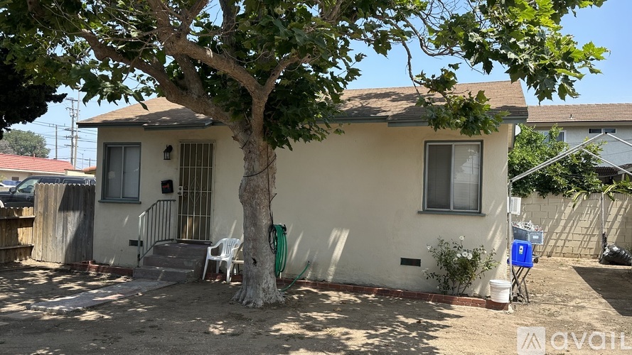 A small house with a tree in front of it.