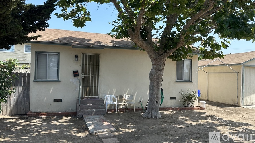 A house with a tree in front of it.