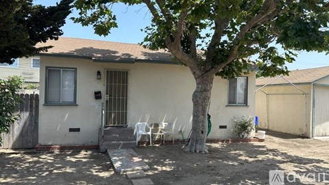 A house with a tree in front of it.