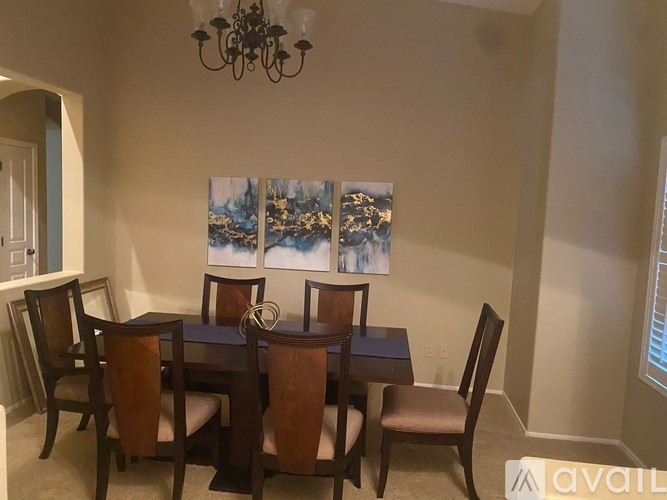 A dining room with a table set for four.