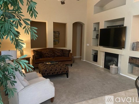 A living room with a leopard print couch and a television.