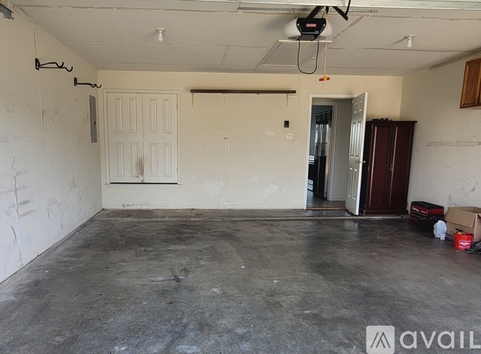 A room with a white door and a brown cabinet.