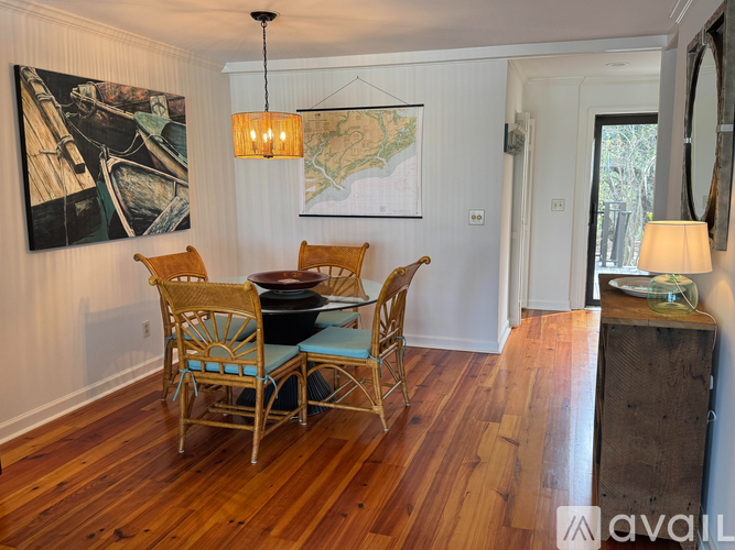 A dining room with a wooden table and chairs.