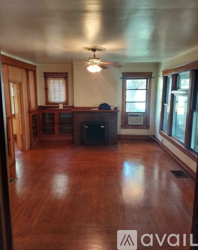 A living room with wood floors and a television.