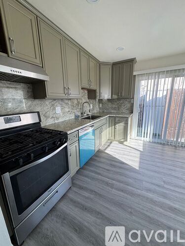 A kitchen with a stove top oven and a counter top.