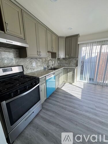 A kitchen with a stove top oven and a counter top.