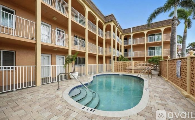A pool in a courtyard surrounded by apartment buildings.